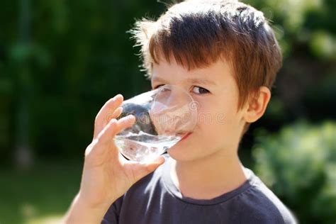 Little Boy Drink Water In Nature Stock Photo Image Of Schoolboy