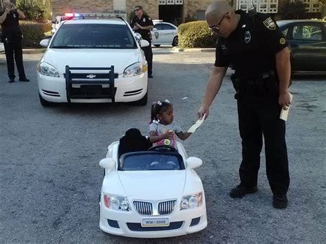 police pull over a 2 year old girl for reckless driving on a toy convertible