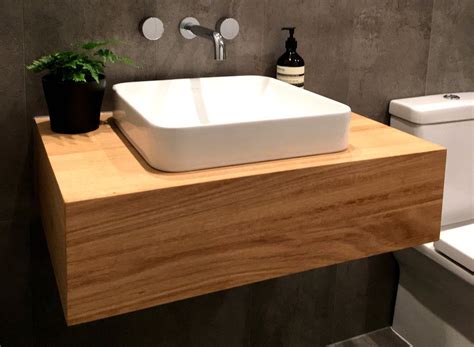 A floating vanity looks smooth while opening up the area in your bathroom. timber floating vanity | Timber bathroom vanities, Wooden ...