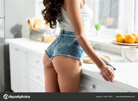 Cropped View Sexy Woman Denim Shorts Standing Worktop Kitchen Stock Photo By VitalikRadko