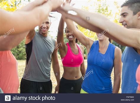 Outdoor Fitness Class Doing A High Five Together Stock Photo Alamy