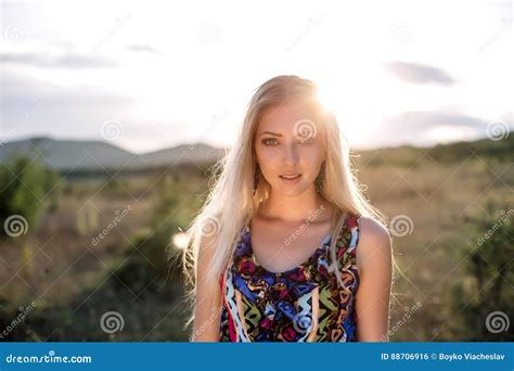 Beautiful Dreamy Blonde Girl With Blue Eyes In A Light Turquoise Dress