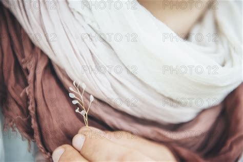 Caucasian Woman Holding Delicate Leaf Near Scarf Photo12 Tetra Images Ivan Evgenyev