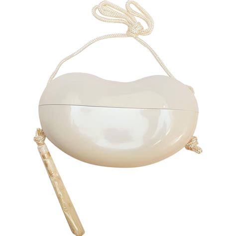 Elsa peretti photographiée par jack mitchell, 1977. Halston Elsa Peretti bean purse off white plastic in box ...