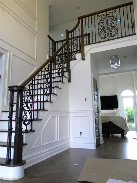 Wood Stairs And Rails And Iron Balusters