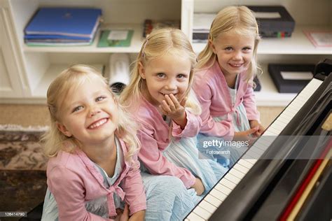 Triplets Playing Piano High Res Stock Photo Getty Images