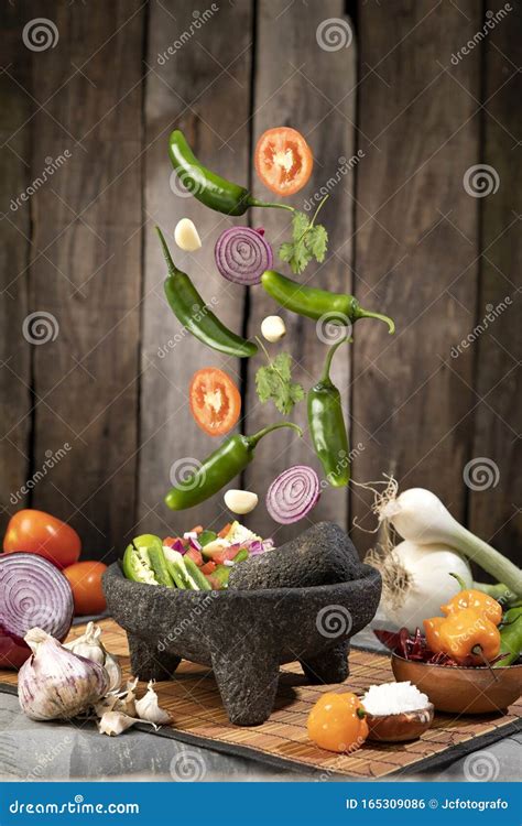 Mexican Red Sauce In A Traditional Molcajete And Ingredients In Kitchen