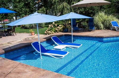 This house, which has been featured on local home tours, includes a small backyard with a rectangular concrete swimming hole surrounded by lawn. 7 Smokin' Hot Trends in Swimming Pool Design for 2019 ...