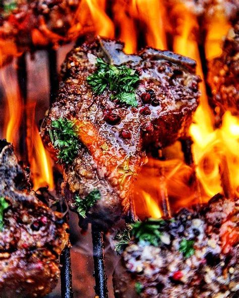 The caul fat wrapping the chops holds the package together while basting the chops as they roast. Christmas lamb loin chops over live fire. Rubbed in a chef's blend of mild chilies roasted ...