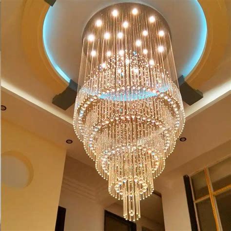 A Large Crystal Chandelier Hanging From The Ceiling In A Room With High