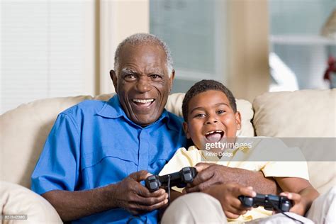 Grandfather And Grandson Playing Video Games High Res Stock Photo