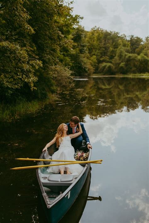 A Bride And Groom In A Row Boat On The Water