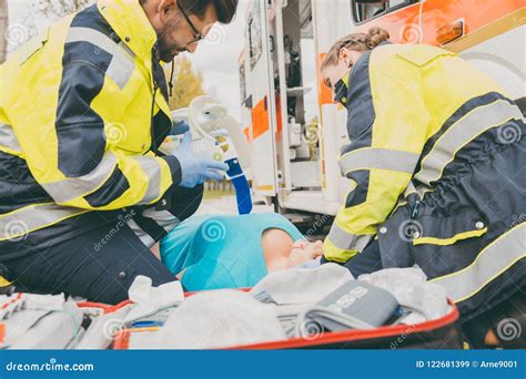 Paramedics Performing First Aid At Ambulance Stock Image Image Of