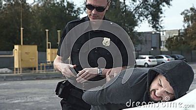 Policeman Arresting Criminal On Parking Lot Stock Footage Video Of Crime Arresting