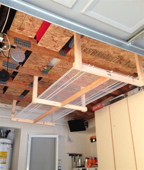 Simple overhead shop storage using ladder hooks and boards. DIY overhead garage storage rack...four 2x3's, and two 8'x16" wire shelves… | Diy overhead ...