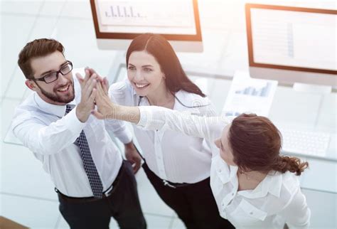 Successful Business Team Giving Each Other A High Five Stock Photo
