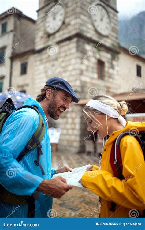 Happy Couple Looking At Map For Directions Young Man And Woman On
