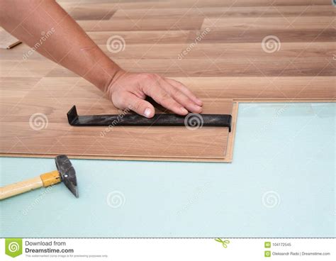 Installing Laminate Flooring Man Installing New Laminate Wood Flooring