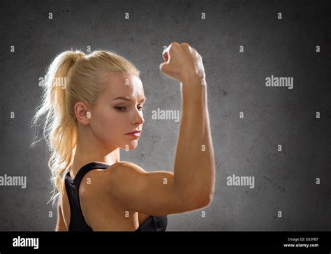 Sporty Woman From The Back Flexing Her Biceps Stock Photo Alamy