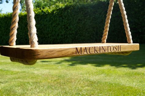 A tree swing needs a horizontal branch at least 8 inches in diameter that is no more clearance: Engraved Oak Swings with Rope | MakeMeSomethingSpecial.com