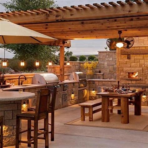 Outdoor Kitchen With Fireplace And Dining Table
