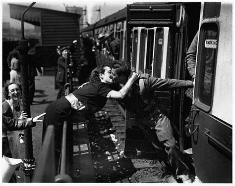 Retro Couples London 1940 A Woman Leans Over The Railing To Kiss A