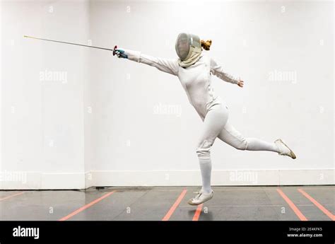 Woman In Fencing Outfit Practicing At Gym Stock Photo Alamy