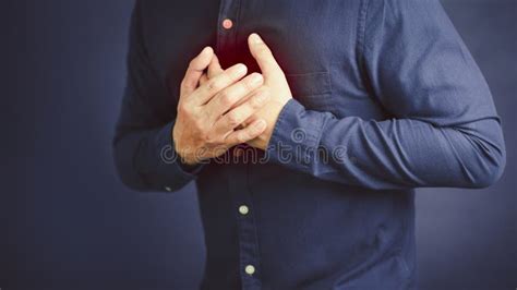 Man Suffering From Chest Pain Hand Pressing On Chest With Painful