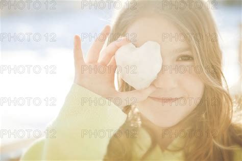Caucasian Girl Covering Eye With Heart Shape Photo12 Tetra Images Shestock