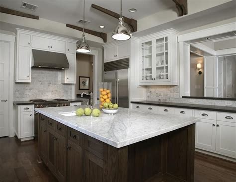Gourmet kitchen features white shaker cabinets with marble countertops, stone subway tile backsplash and gorgeous kitchen island. carrara marble subway tile backsplash photos from Carrara ...