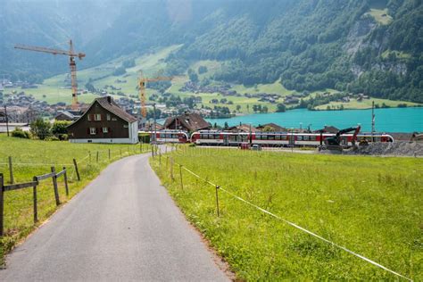 View Of Swiss Village Lungern With Traditional Houses Along The Lake
