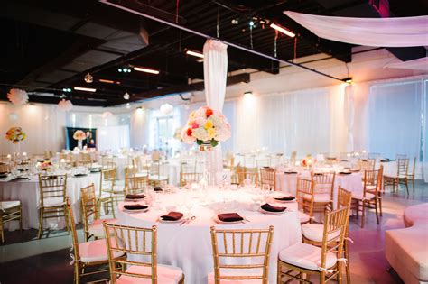 Modern Wedding Reception With Pom Poms And Glass Globes Suspended Over