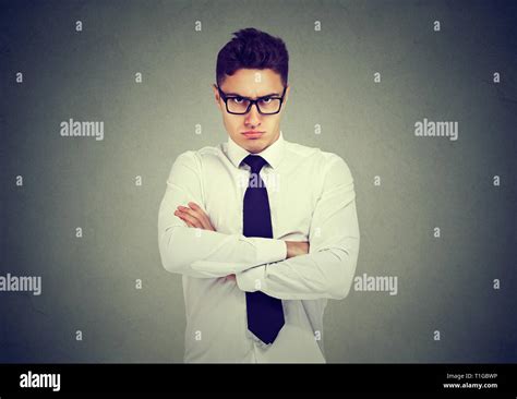 Frowning Angry Business Man Looking At Camera On Gray Wall Background