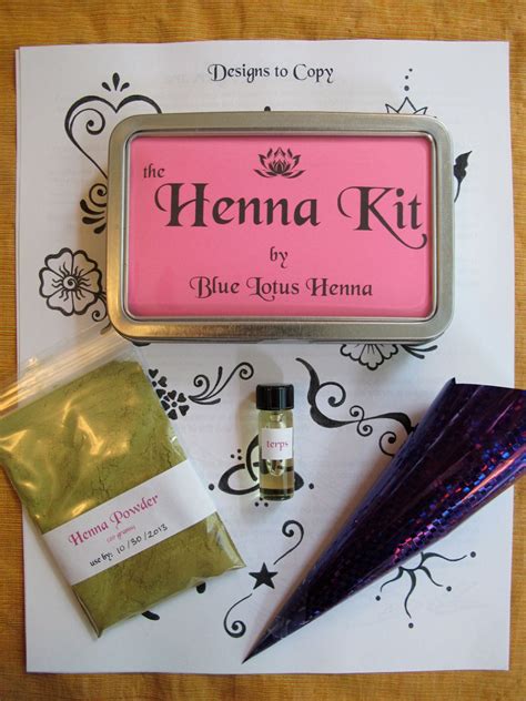 The Henna Kit Is Sitting On Top Of A Piece Of Paper Next To Its Contents