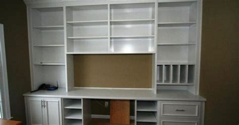 Well appointed features a white built in shelving unit fitted to gray walls featuring gray open shelves with charcoal gray backs lit by boston functional library wall lights flanking a mounted flat panel television positioned over white. Custom Built White Bookcase Wall Unit | Home office ideas ...