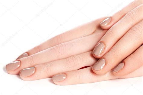 Beautiful Female Finger Nails With Beige Nail Closeup On Petals