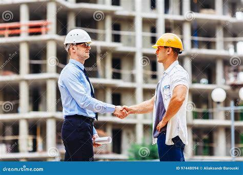 Architect Engineer Shaking Hands Other Hand At Construction Site