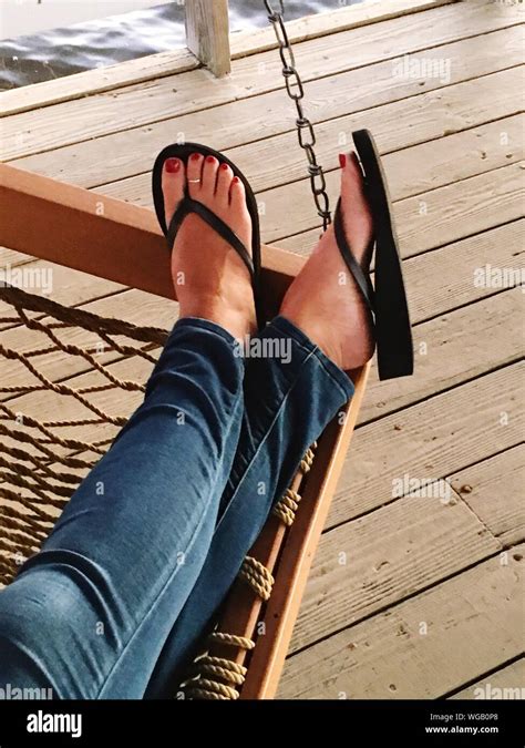 Crossed Legs Flip Flops Hi Res Stock Photography And Images Alamy