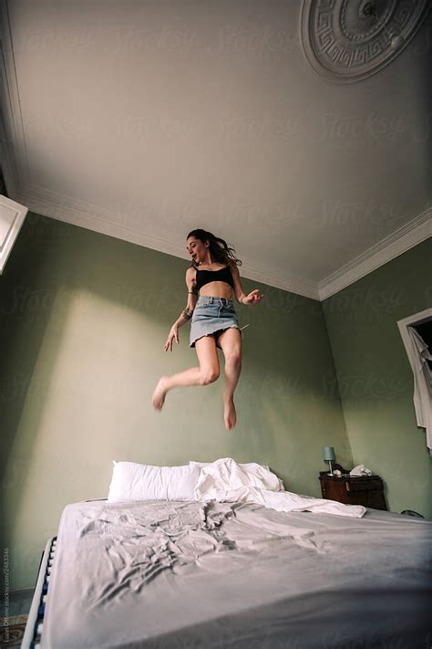 Woman Jumping On Bed By Stocksy Contributor Lucas Ottone Stocksy