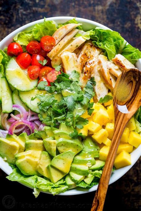 Step 4 arrange greens, mango, and avocado on 4 serving plates. Chicken Mango Avocado Salad recipe in a bowl served like ...