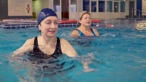 Group Of Senior Women Doing Aqua Aerobics Exercises In The Swimming