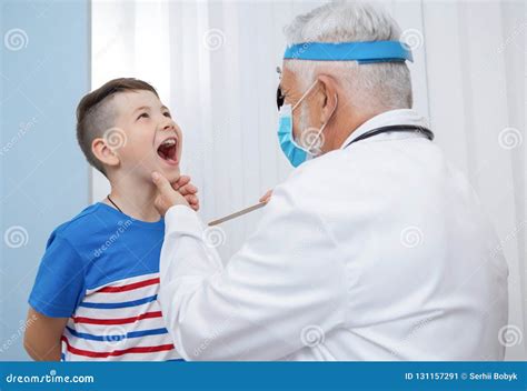 Ent Doctor Examining Throat Of Kid Stock Image Image Of Consultation