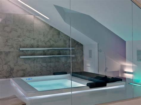 A small elegant attic bathroom with white subway tiles, a black clad bathtub and vanity, a white tub and sink (lauren bryan knight) a contemporary attic bathroom with large windows, an oval bathtub, a vanity with a round mirror, a wooden stool (velux) Picture Of Cool Attic Bathroom Design Ideas