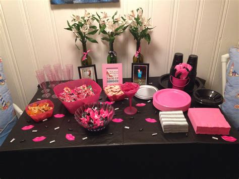 The Table Is Set Up With Pink And Black Decorations