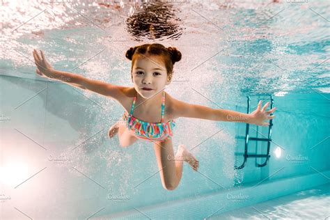 Adorable Kid Swimming Underwater In High Quality People Images
