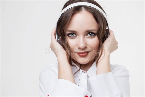 Happy Girl Listen Music In White Headphones And Smiling Stock Image