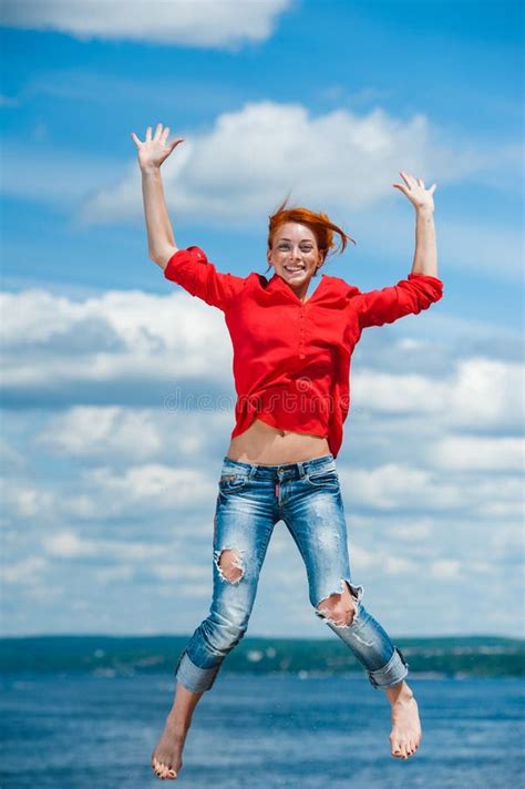 Woman Jumps While Walking Near The Wall Outdoors Stock Photo Image