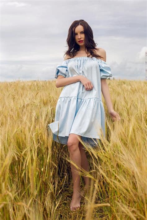 Woman In A Blue Light Dress Stands In A Field Stock Photo Image Of