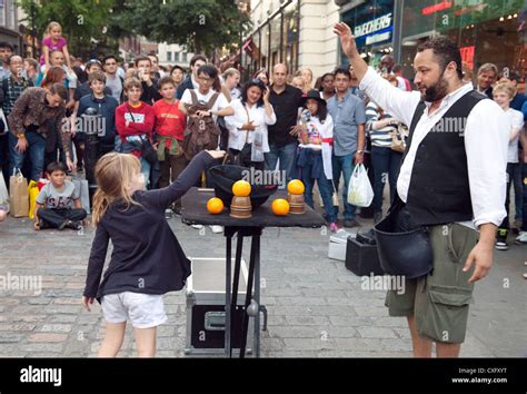 A Child Giving Money To A Street Performer Covent Garden London Uk