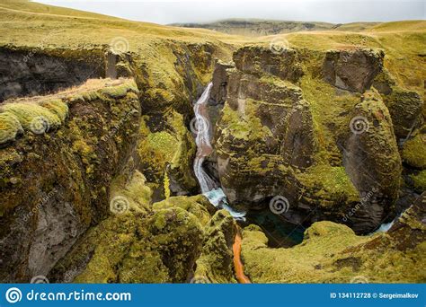 Deep Canyon Steep Cliffs Overgrown With Green Moss Surrounded By A